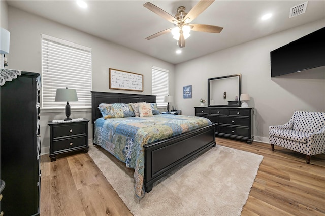 bedroom with ceiling fan and light wood-type flooring