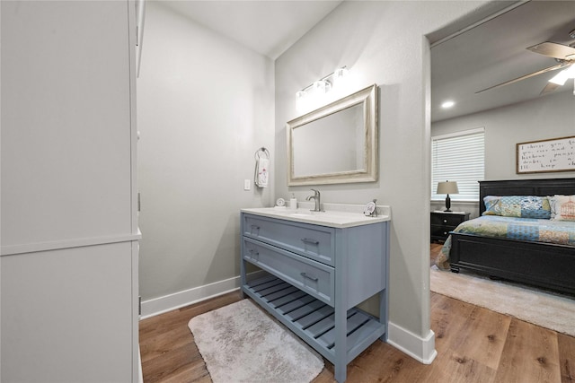 bathroom featuring vanity, wood-type flooring, and ceiling fan