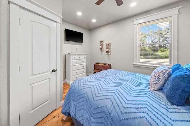 bedroom with ceiling fan and light hardwood / wood-style floors