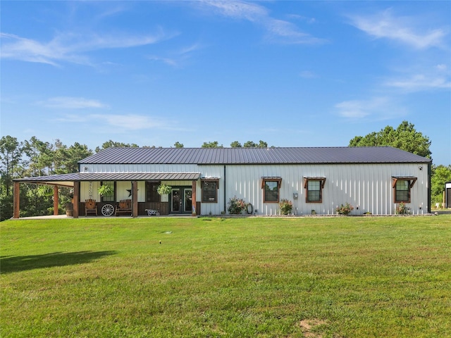 rear view of property with a carport and a yard