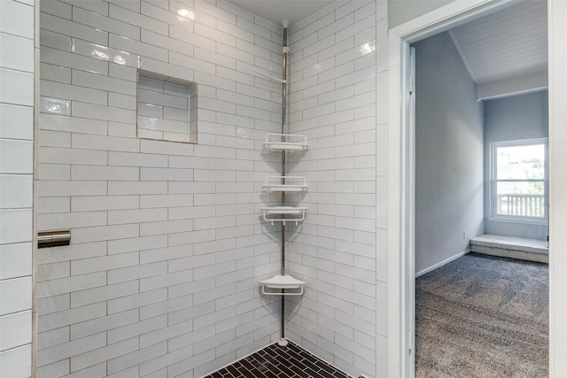 bathroom with tiled shower