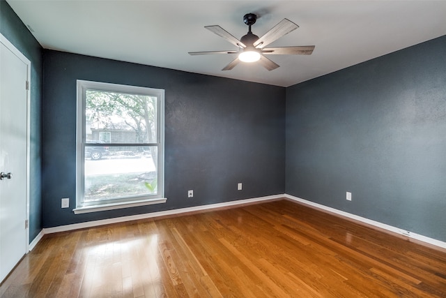 unfurnished room with ceiling fan and hardwood / wood-style flooring