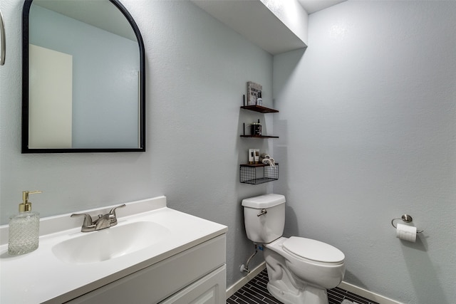 bathroom with tile patterned floors, vanity, and toilet