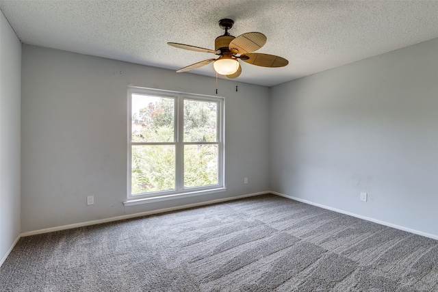 spare room featuring ceiling fan, carpet floors, and a textured ceiling