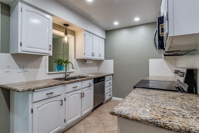 kitchen with stainless steel appliances, recessed lighting, white cabinetry, a sink, and light tile patterned flooring