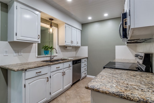 kitchen featuring light stone counters, stainless steel dishwasher, sink, white cabinets, and range