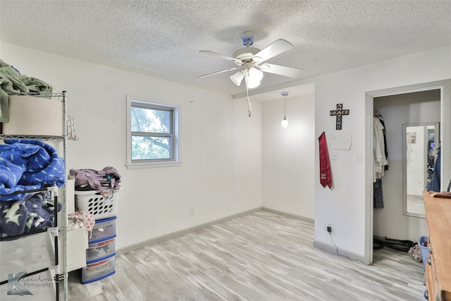 bedroom featuring ceiling fan, a textured ceiling, and hardwood / wood-style flooring