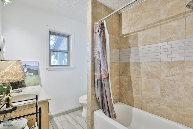 full bathroom featuring shower / bath combination with curtain, a textured ceiling, toilet, vanity, and hardwood / wood-style flooring