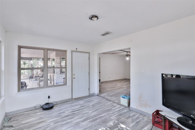 living room featuring ceiling fan and light wood-type flooring