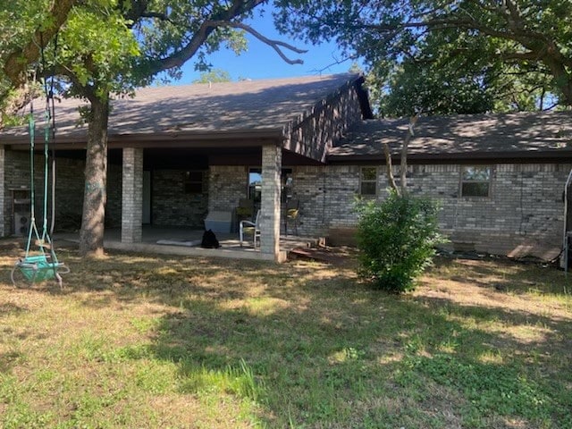 back of house featuring a patio and a yard