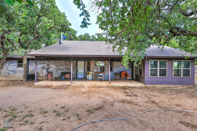 rear view of property featuring a patio area and cooling unit