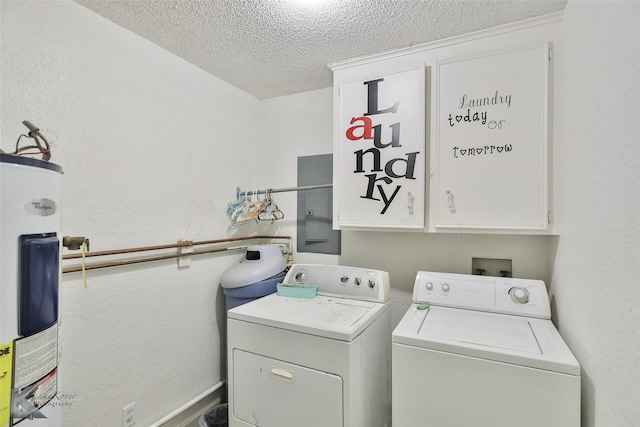 washroom featuring electric water heater, washer and dryer, cabinets, and a textured ceiling