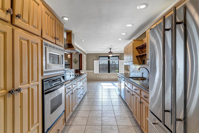 kitchen featuring island exhaust hood, sink, ornamental molding, ceiling fan, and stainless steel appliances