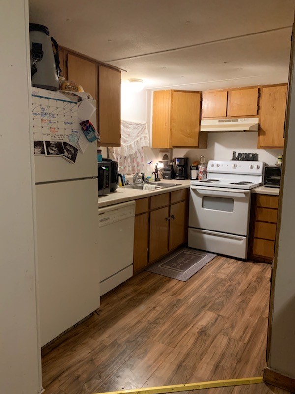 kitchen with sink, light hardwood / wood-style flooring, and white appliances