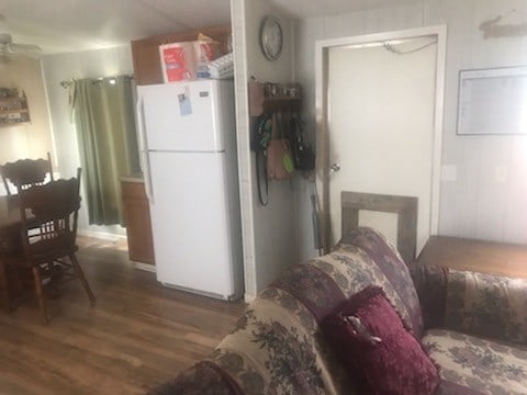 kitchen with white refrigerator, ceiling fan, and dark wood-type flooring