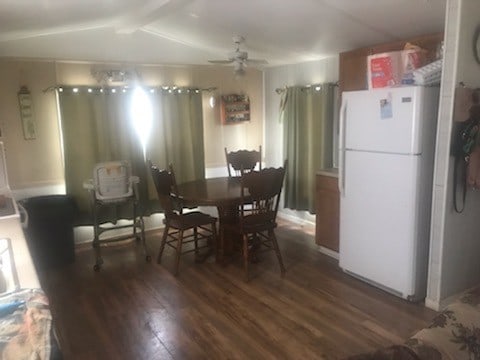 dining area with ceiling fan and dark hardwood / wood-style floors