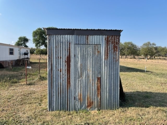 view of outbuilding with a yard