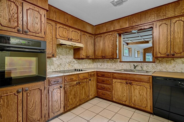 kitchen featuring sink, black appliances, light tile patterned floors, and vaulted ceiling