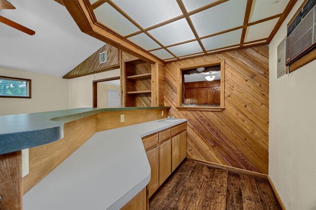 kitchen with wood walls, sink, and hardwood / wood-style floors