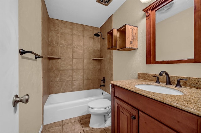 full bathroom featuring toilet, tile patterned floors, tiled shower / bath combo, and vanity