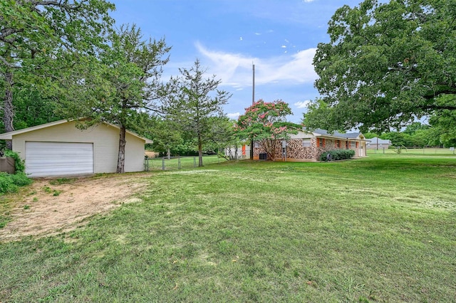 view of yard with a garage and an outdoor structure