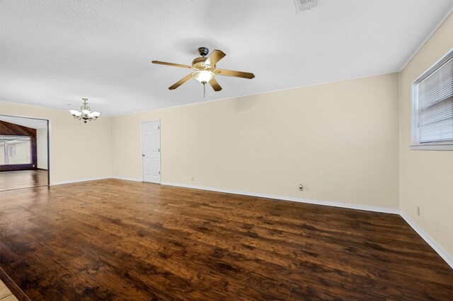 unfurnished room with ceiling fan with notable chandelier and wood-type flooring