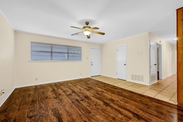 unfurnished room with ceiling fan and light hardwood / wood-style floors