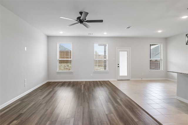 unfurnished room with ceiling fan and hardwood / wood-style flooring