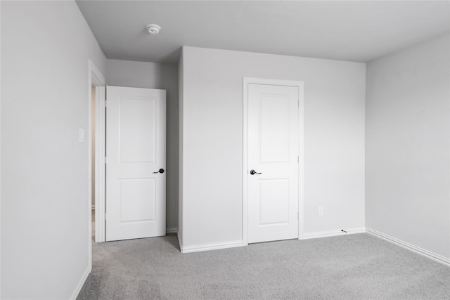 unfurnished bedroom with light colored carpet