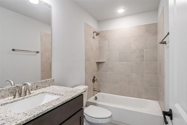 full bathroom with toilet, tiled shower / bath combo, and vanity