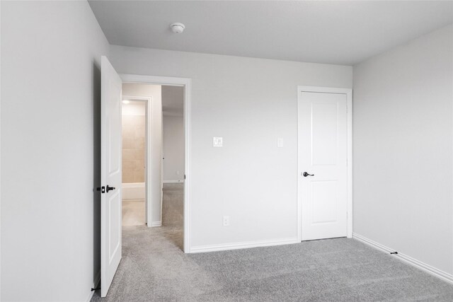 unfurnished bedroom with light colored carpet