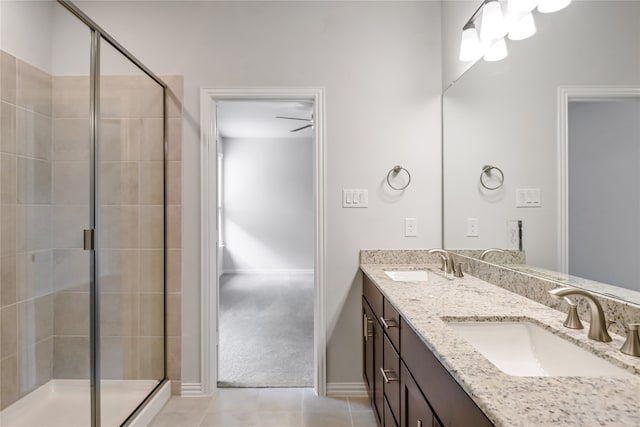 bathroom with tile patterned flooring, walk in shower, and vanity