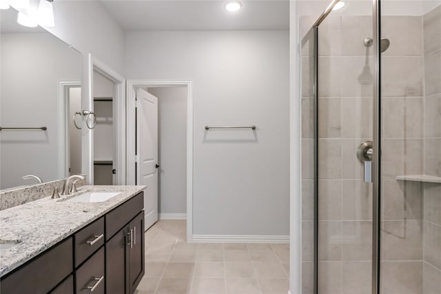 bathroom featuring vanity, an enclosed shower, and tile patterned flooring