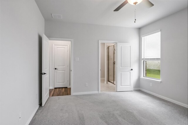 unfurnished bedroom featuring ceiling fan and light carpet