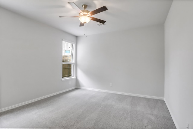 empty room with ceiling fan and carpet