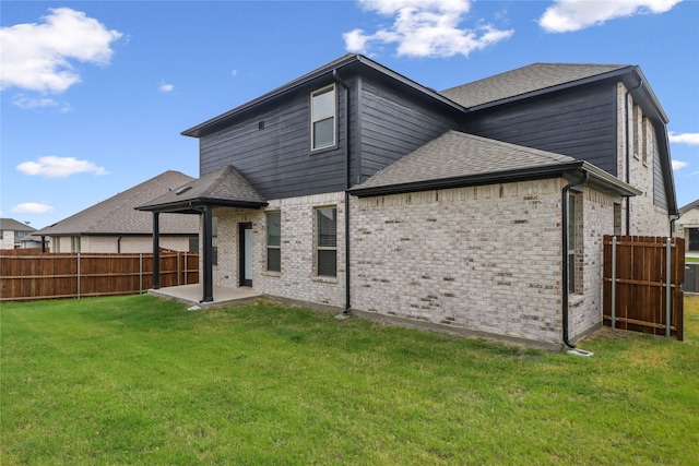 rear view of property with central AC, a lawn, and a patio area