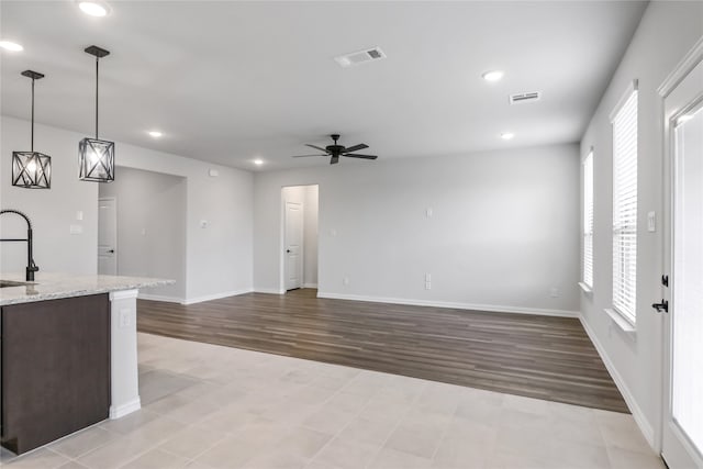 interior space featuring light hardwood / wood-style flooring, sink, and ceiling fan