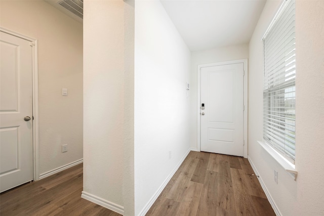 hallway with wood-type flooring