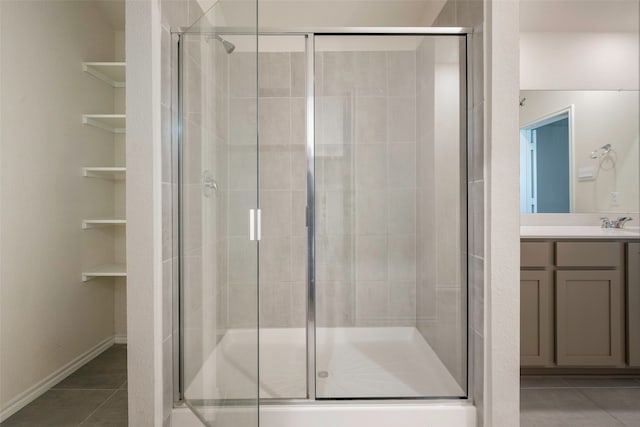 bathroom with vanity, an enclosed shower, and tile patterned flooring