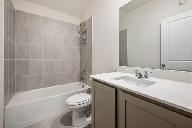 full bathroom featuring vanity, tile patterned floors, tiled shower / bath, and toilet