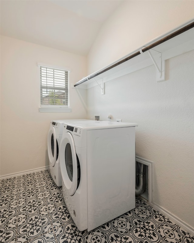 washroom featuring washing machine and clothes dryer and light tile patterned floors