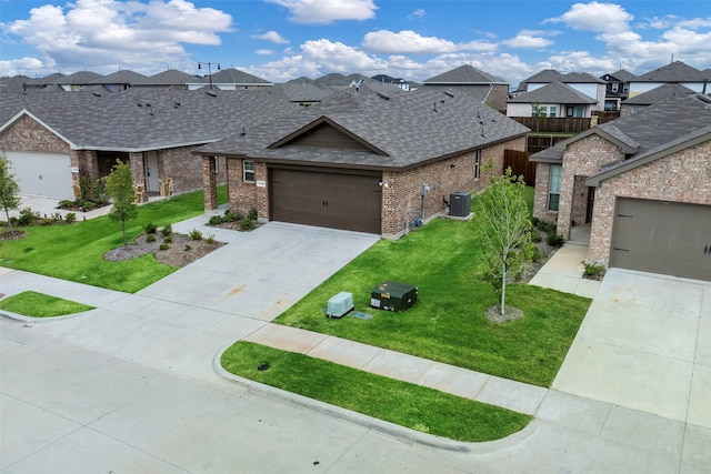 view of front of property with a garage, cooling unit, and a front yard