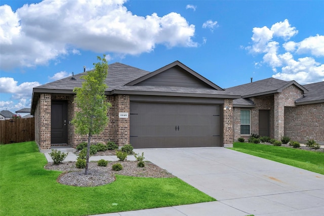 view of front of home featuring a garage and a front yard