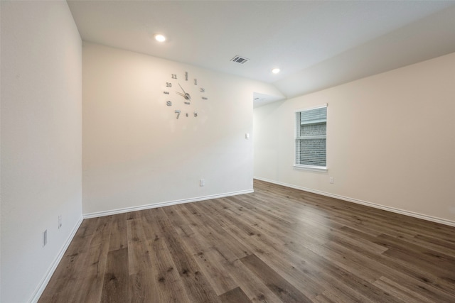 spare room with lofted ceiling and hardwood / wood-style floors