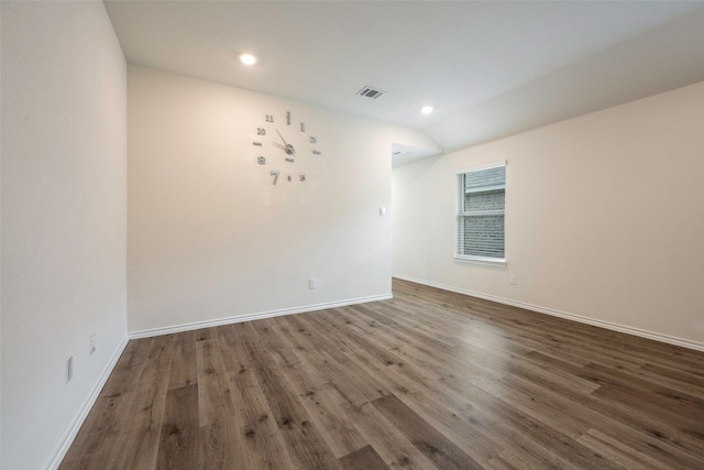 empty room with lofted ceiling and dark hardwood / wood-style flooring