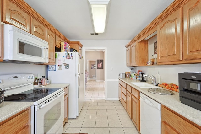 kitchen with sink, light tile patterned floors, and white appliances