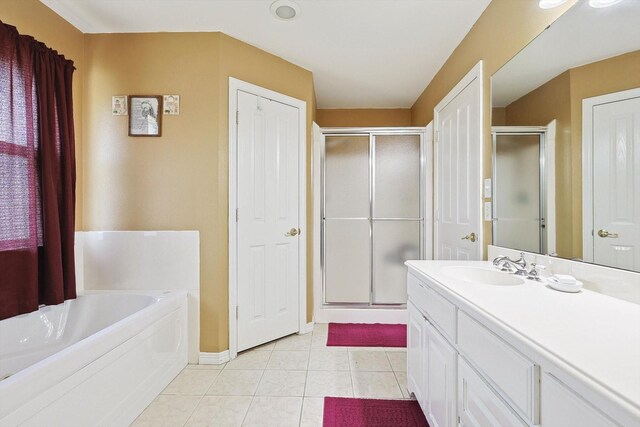 bathroom featuring shower with separate bathtub, tile patterned floors, and vanity