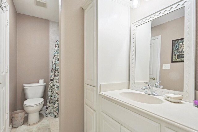 bathroom featuring tile patterned floors, toilet, and vanity