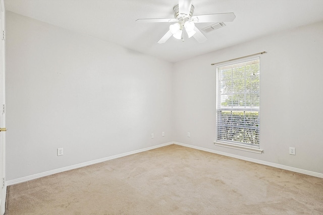 empty room with light colored carpet and ceiling fan