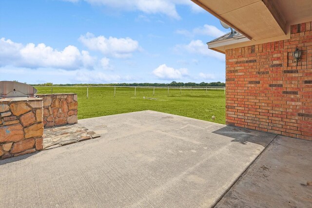 view of patio / terrace with an outdoor kitchen, grilling area, and a rural view